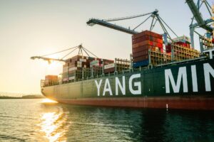 container ship in harbor at sunset