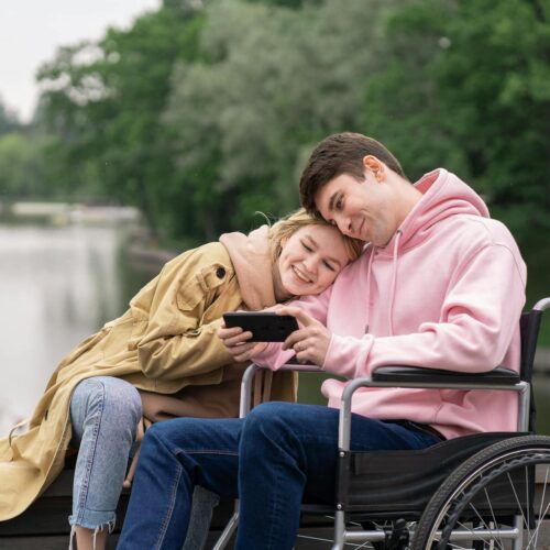 a woman and man looking the smartphone together
